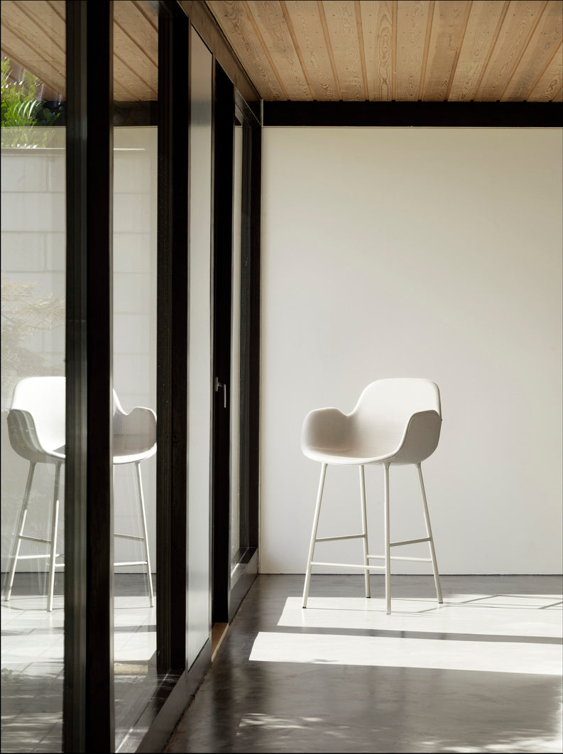 Bar chair upholstered with armrests of forms with a light gray base