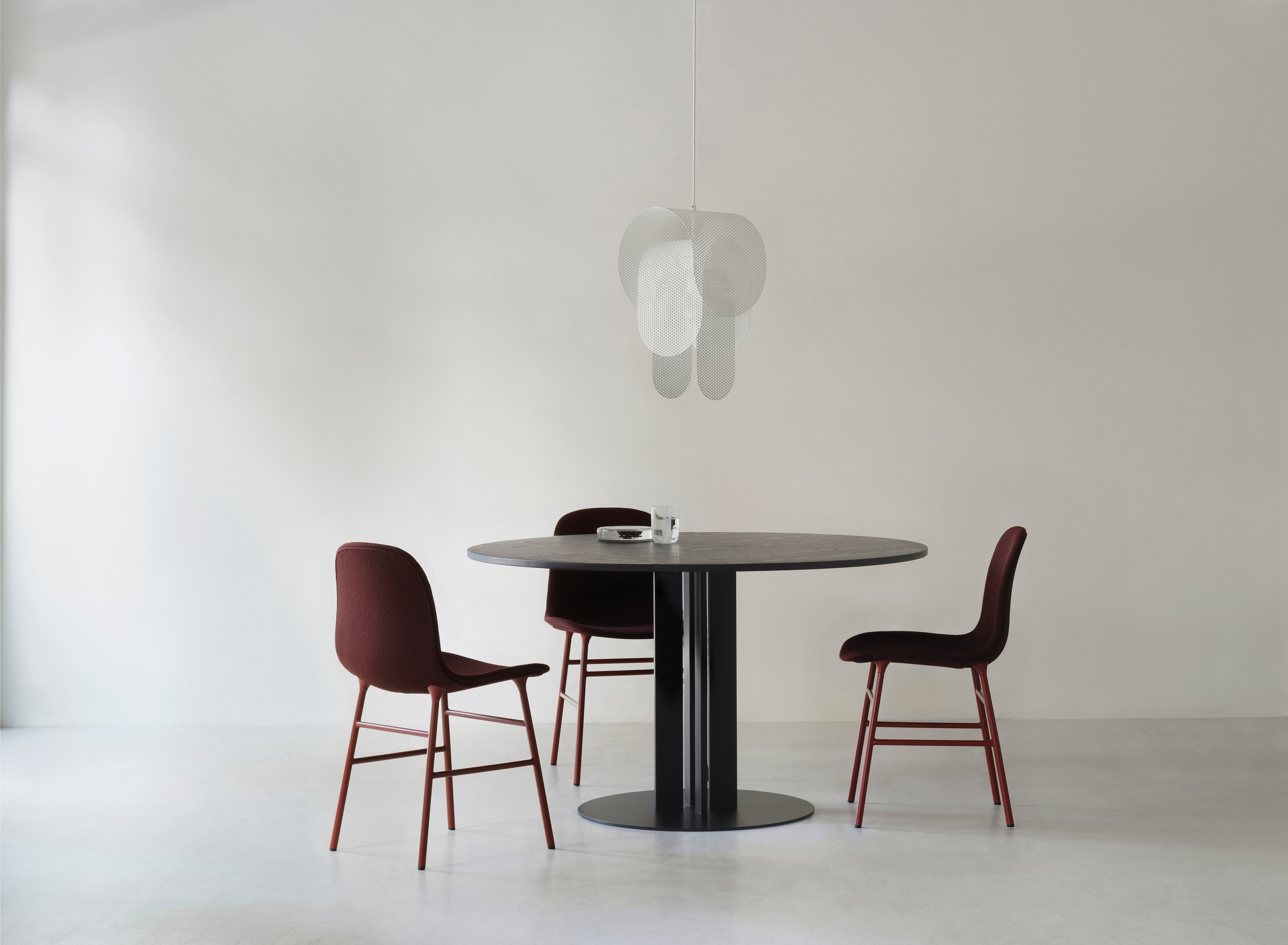 Upholstered chair forms with a black base