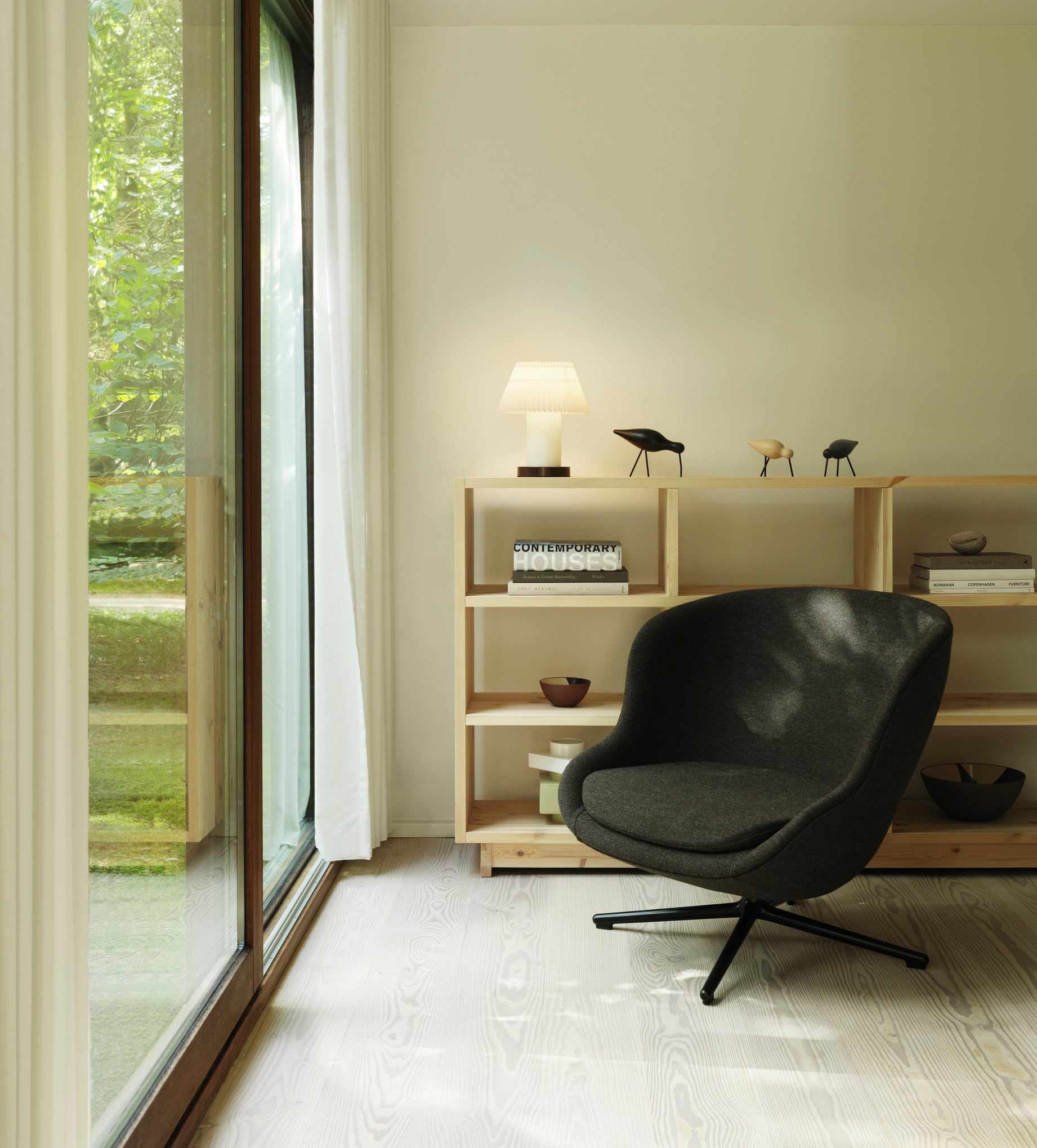 Hyg Low upholstered armchair with a black base
