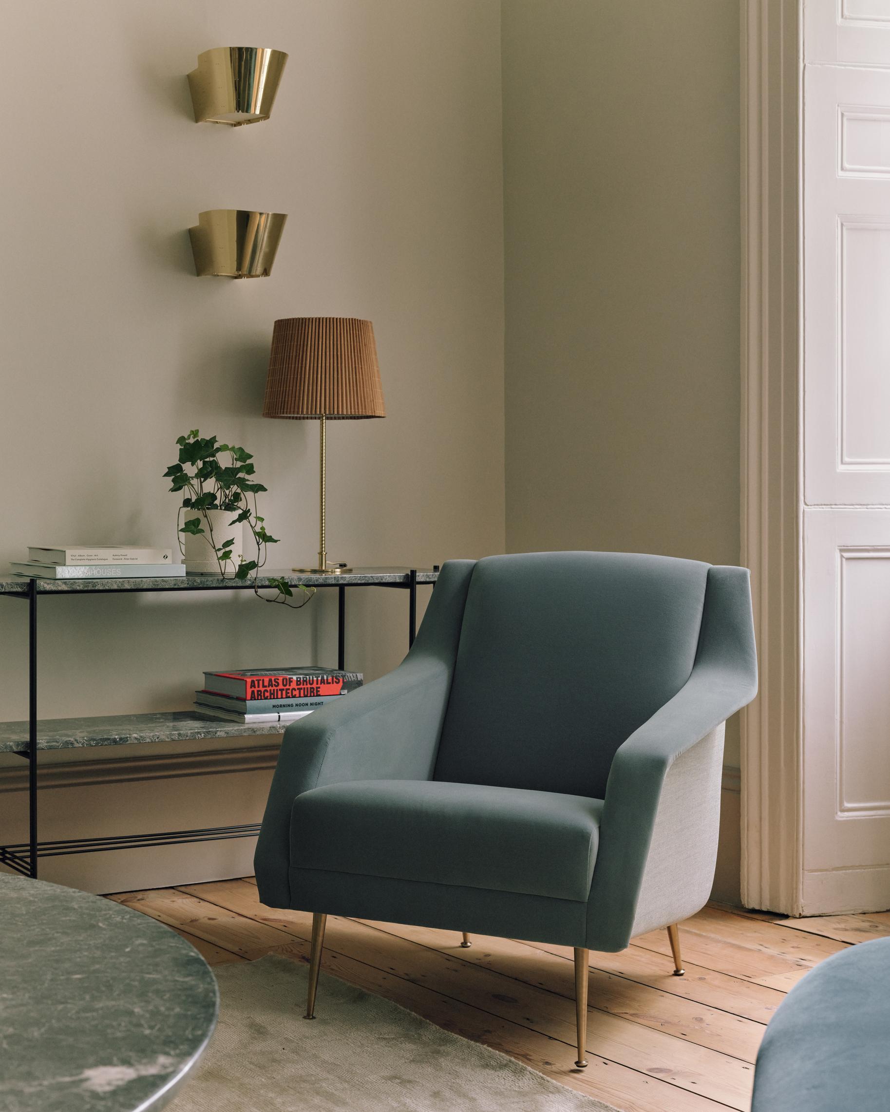 CDC.1 upholstered armchair with a brass base