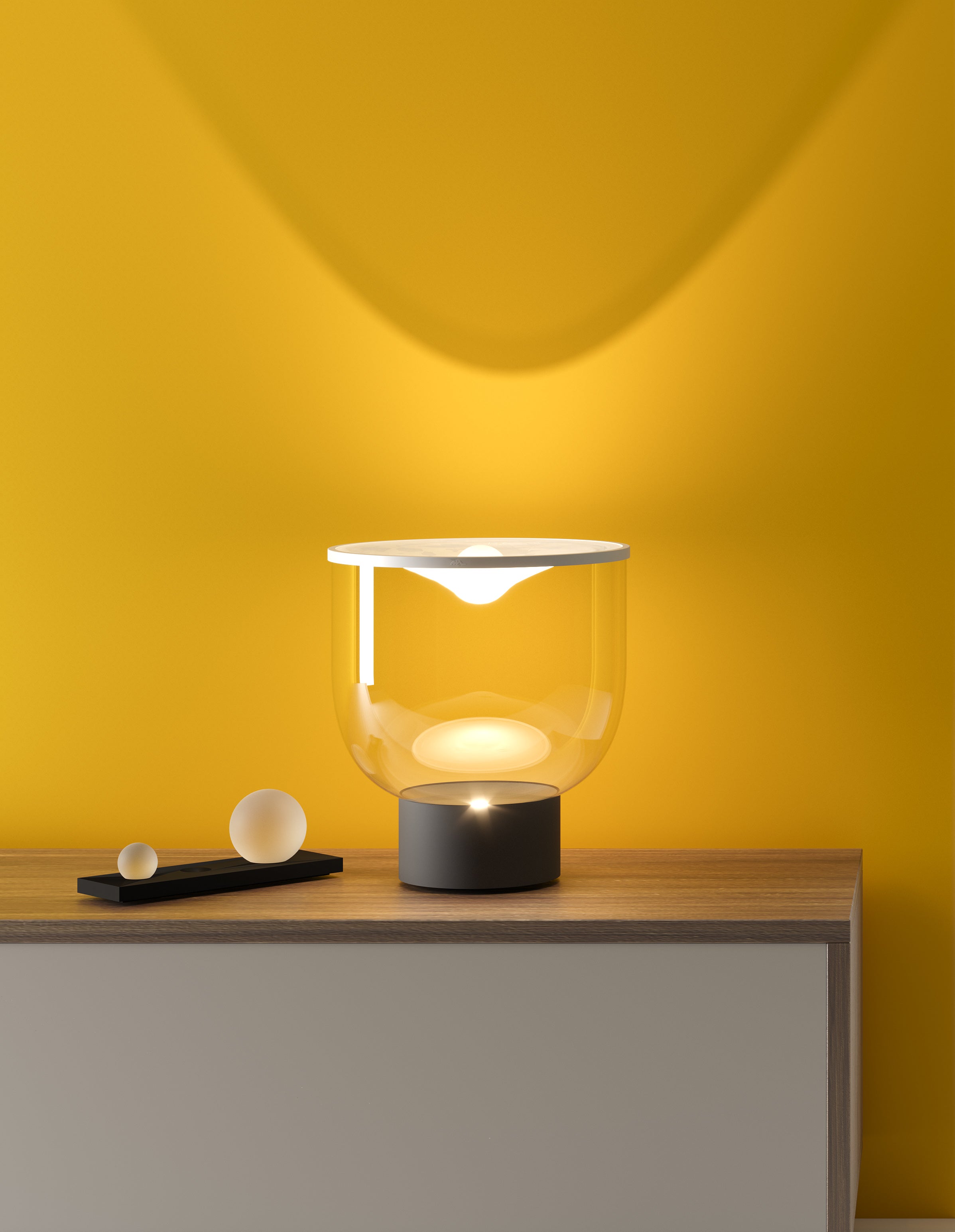 GRAMMOLUCE table lamp with a glass shade and black base.