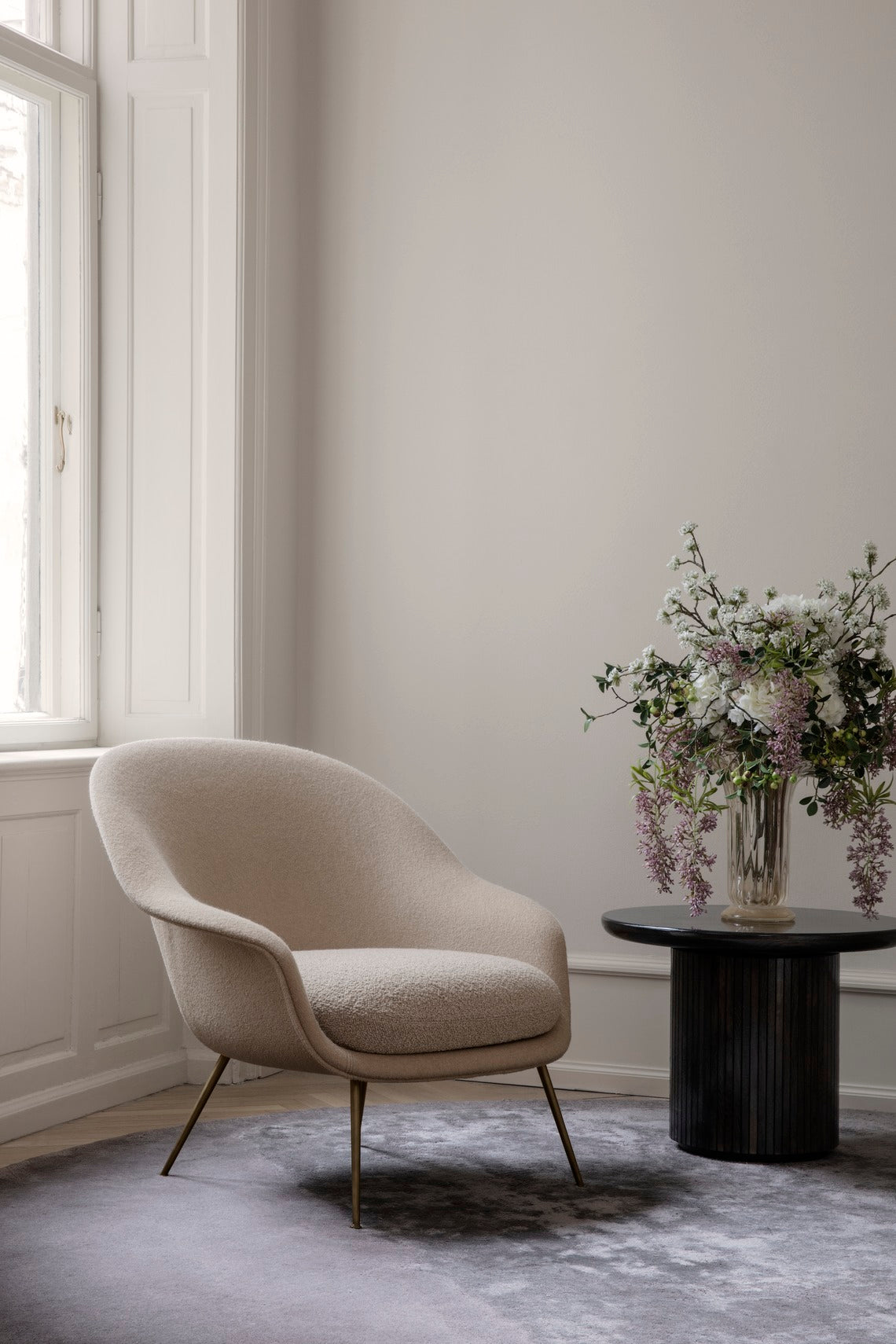 Upholstered BAT armchair with black base