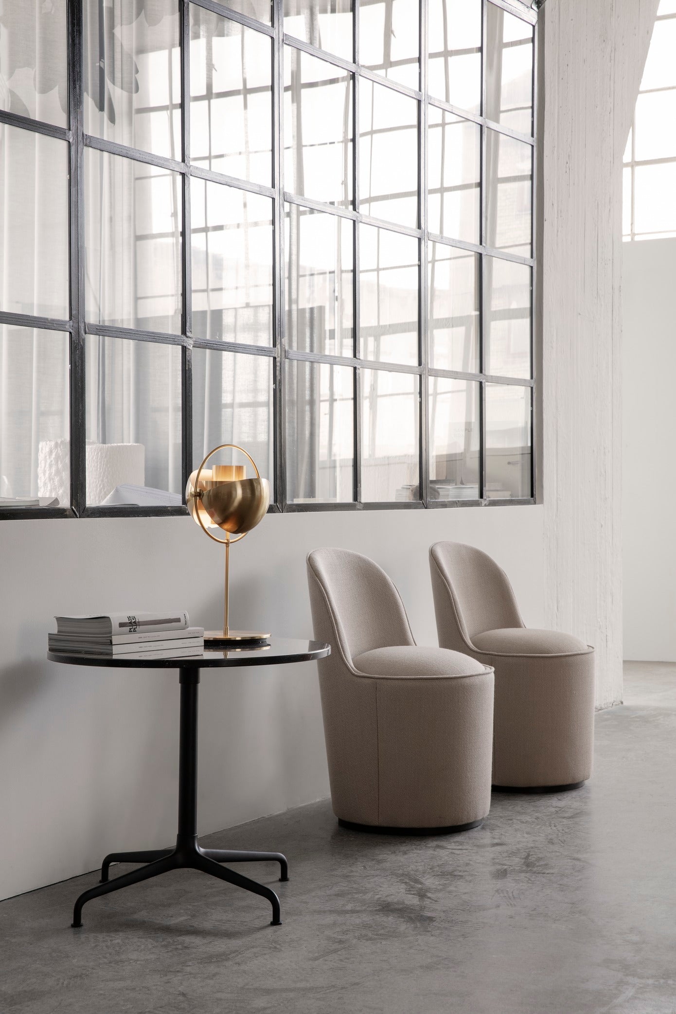 Upholstered TAIL armchair with a black base