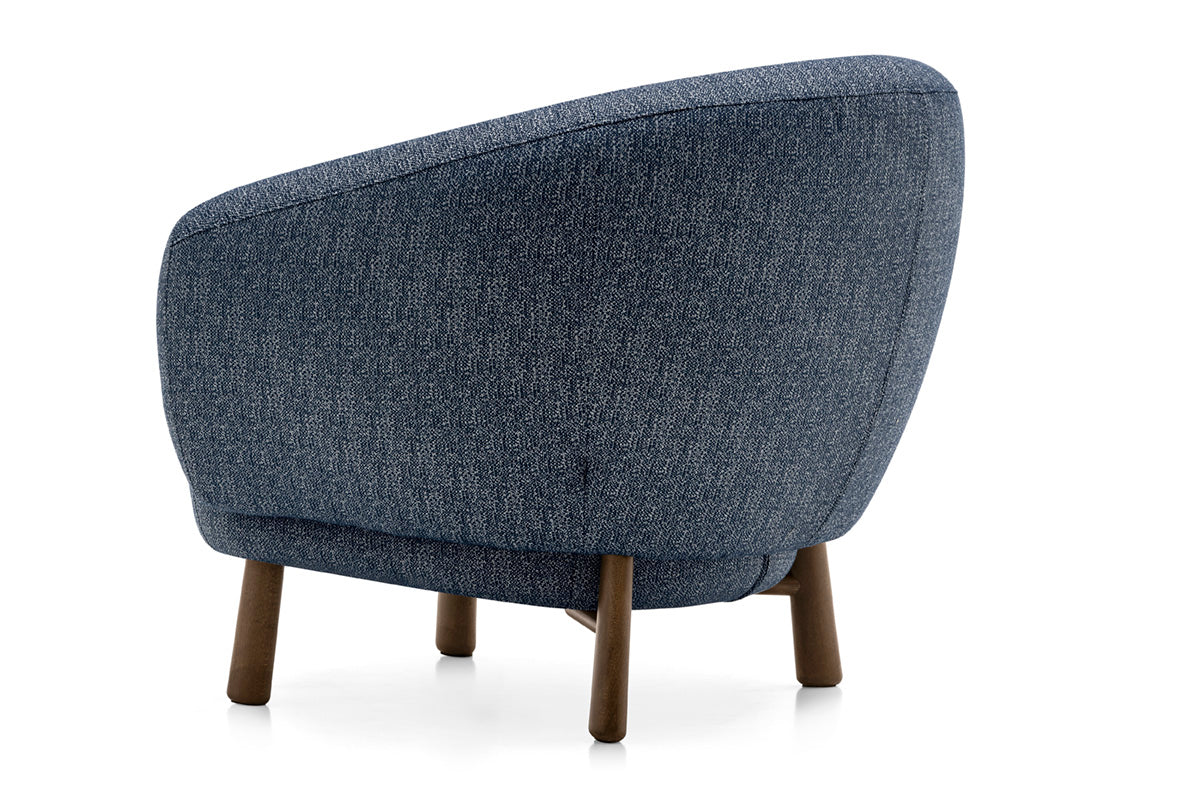 Upholstered RIO armchair with a dark wooden base