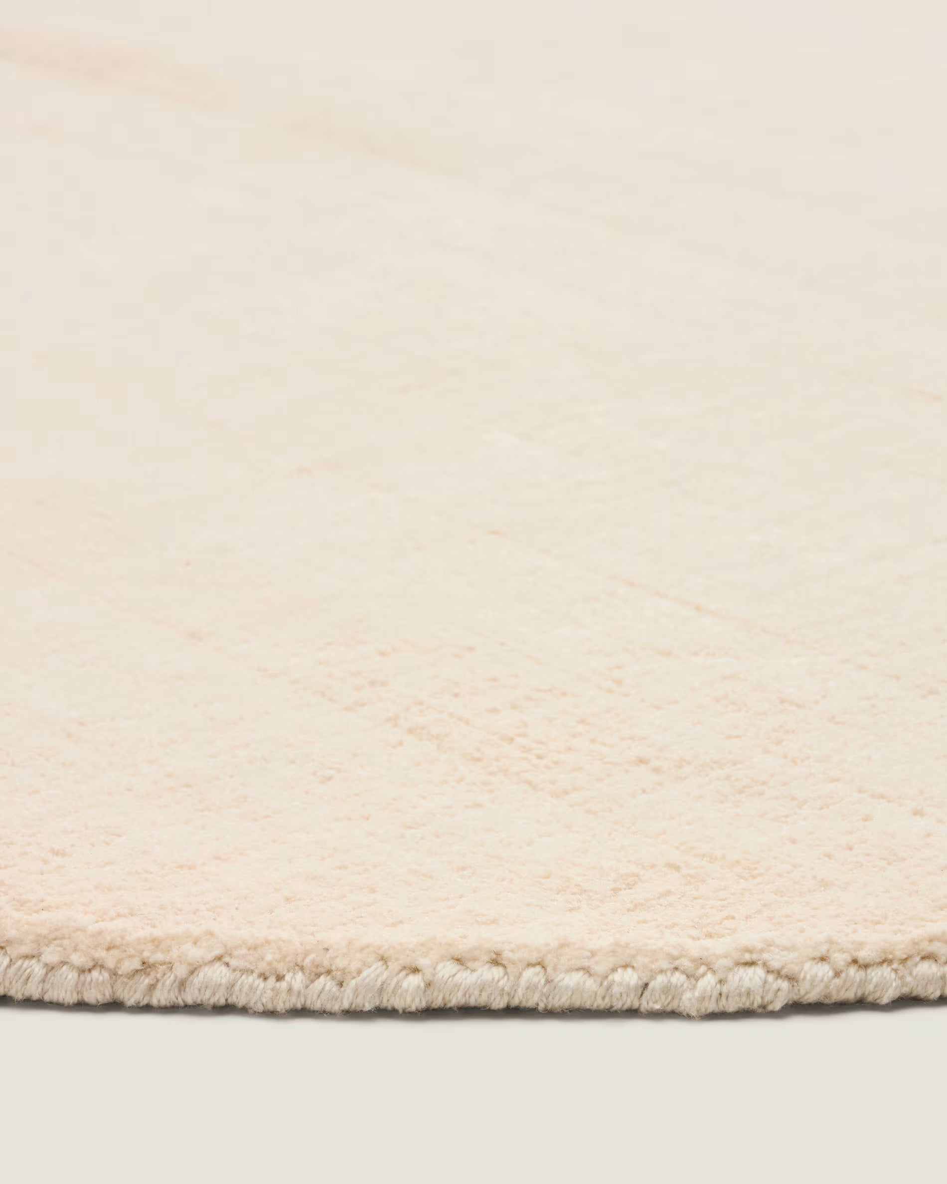 Beige round rug EMPURIES