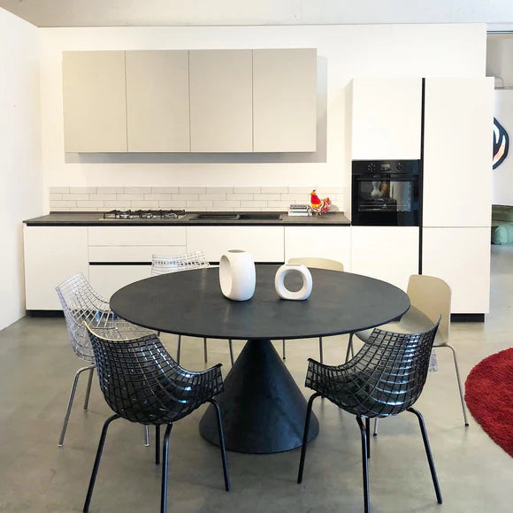 A transparent meridiana chair with a black base