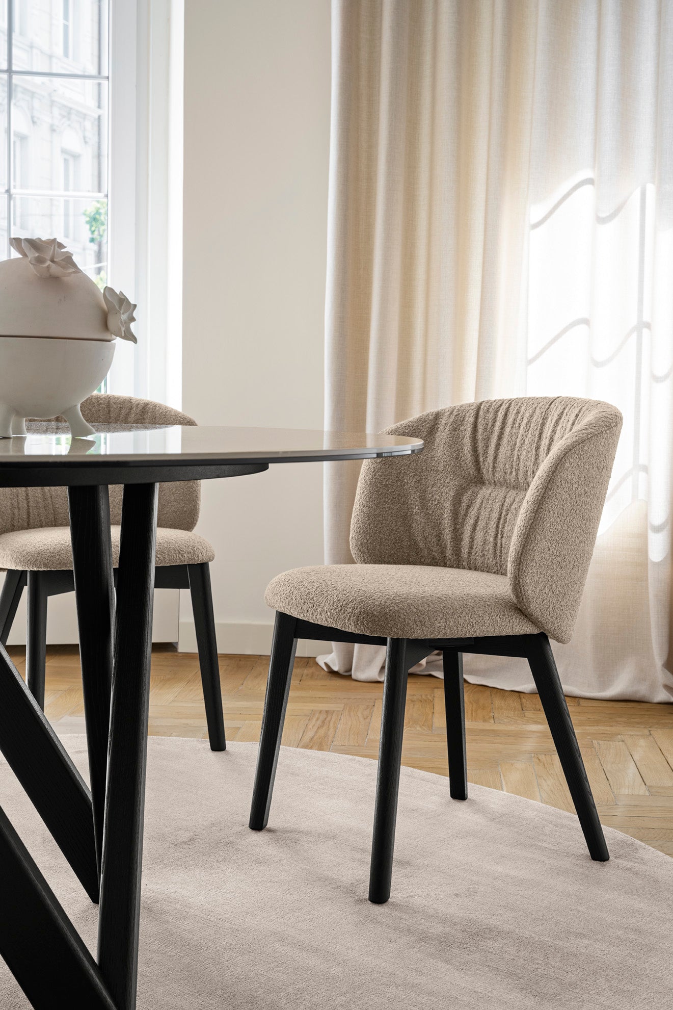 Upholstered SWEEL chair with a dark wooden base