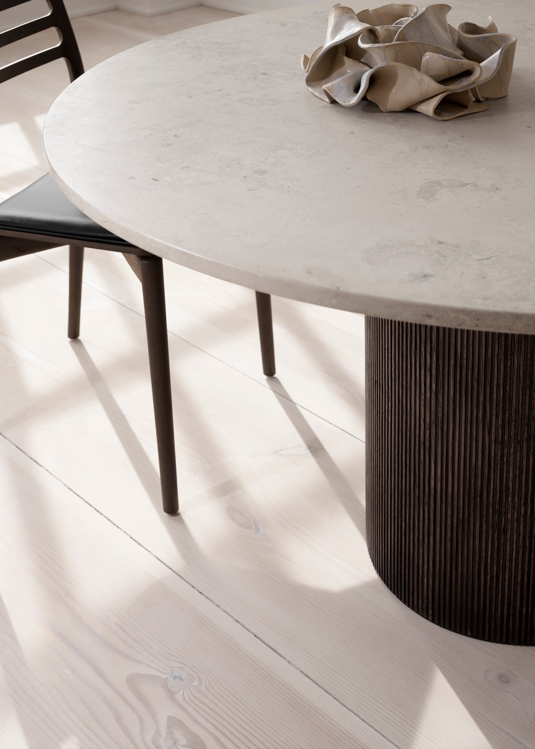 Round Table CABIN with a gray limestone top and a dark oak base